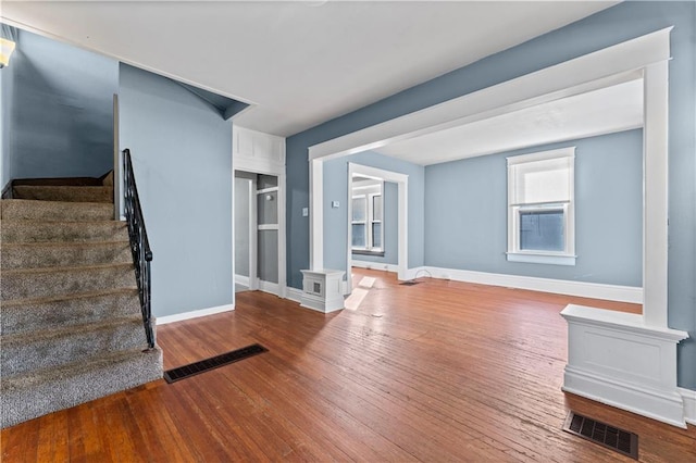 unfurnished living room featuring hardwood / wood-style flooring