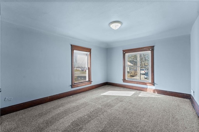 unfurnished room featuring carpet