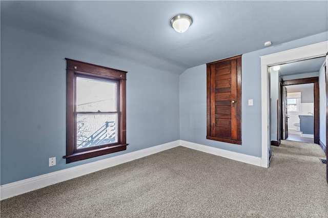 spare room featuring plenty of natural light and carpet