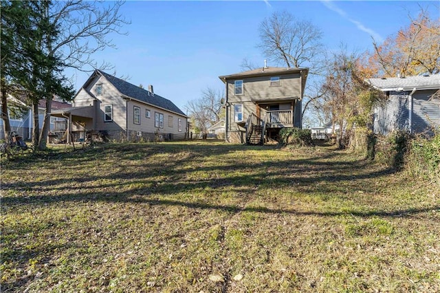 rear view of house featuring a lawn