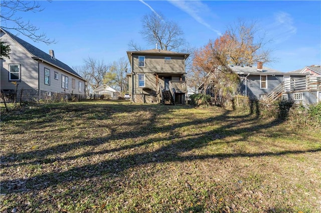 rear view of property featuring a lawn