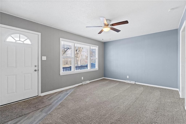 entryway featuring ceiling fan, wood-type flooring, and a textured ceiling