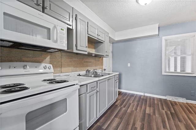 kitchen with white appliances, sink, gray cabinets, tasteful backsplash, and dark hardwood / wood-style flooring