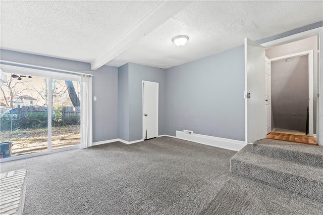 interior space with beam ceiling and a textured ceiling