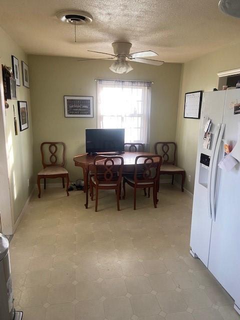 dining space featuring ceiling fan