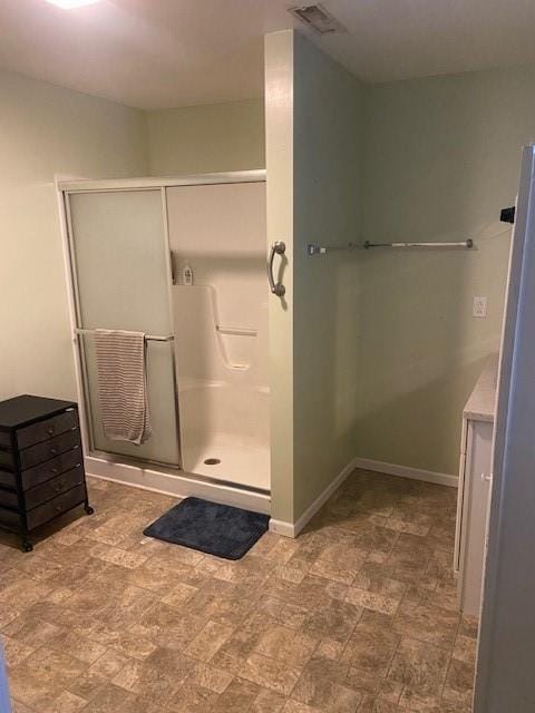 bathroom featuring a shower with shower door