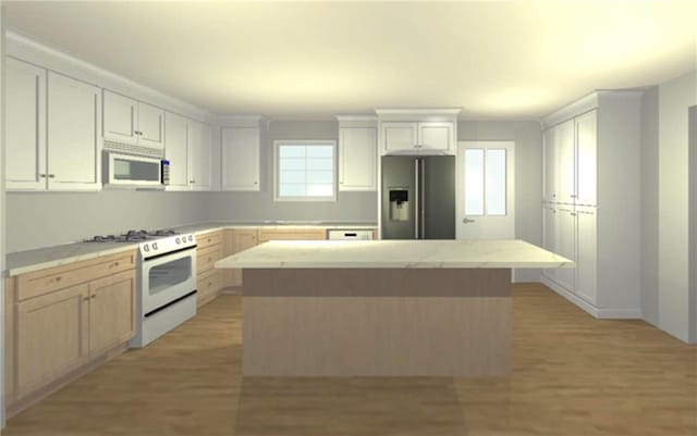 kitchen with white cabinetry, a center island, stainless steel appliances, and light wood-type flooring