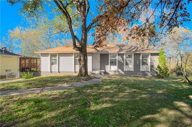 single story home with a sunroom and a front lawn