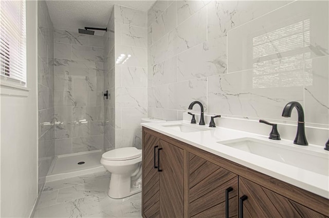 bathroom featuring vanity, toilet, tiled shower, and tile walls