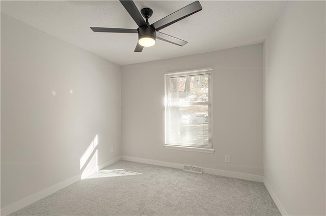 empty room with light carpet and ceiling fan