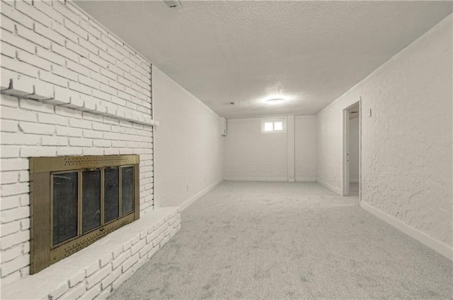 basement featuring a fireplace, carpet, and a textured ceiling