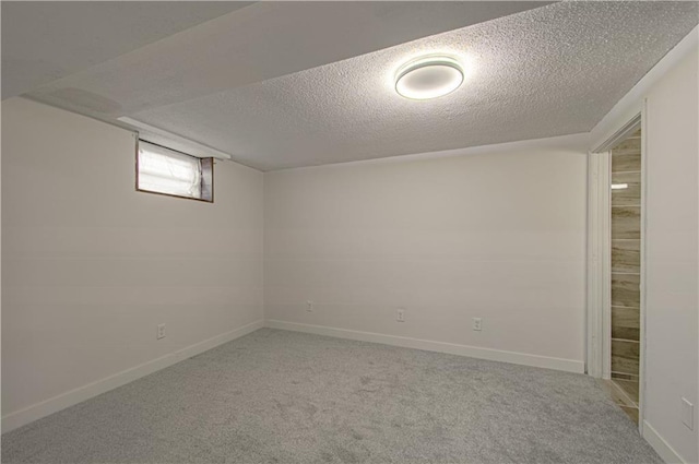 basement with carpet flooring and a textured ceiling