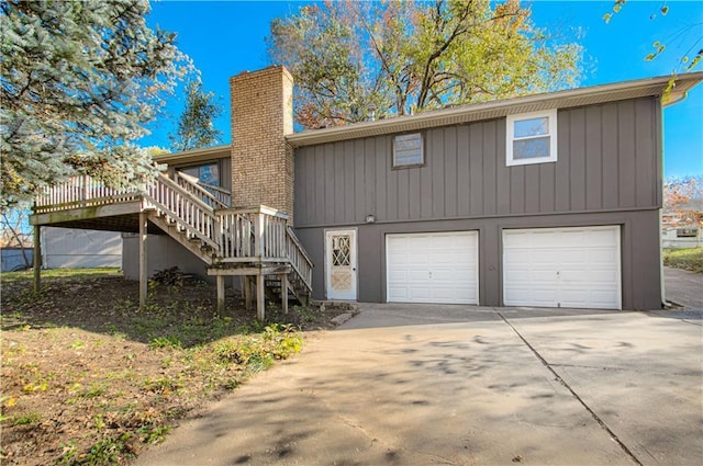 back of house featuring a wooden deck and a garage