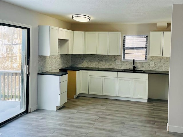 kitchen with sink, white cabinets, and plenty of natural light