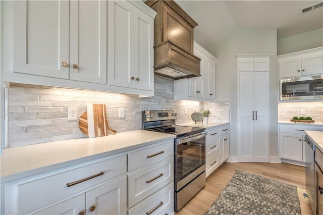 kitchen featuring white cabinetry, visible vents, appliances with stainless steel finishes, and light countertops