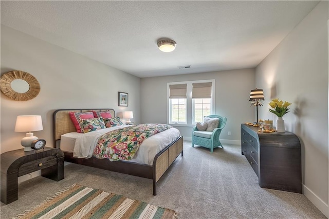 carpeted bedroom featuring baseboards and visible vents