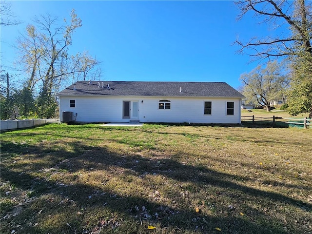 rear view of house with a patio area, a yard, and central AC