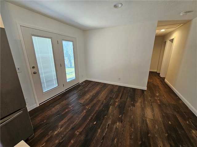 spare room with dark hardwood / wood-style flooring