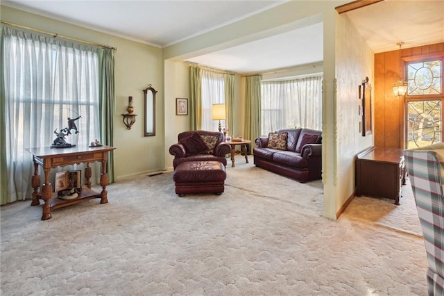 living area with light carpet, crown molding, and wood walls