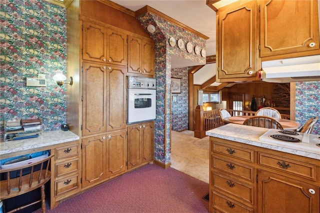 kitchen with carpet, white appliances, and ornamental molding