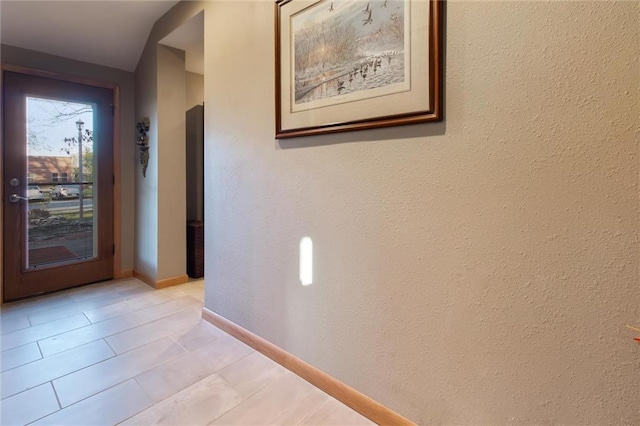 hallway with light tile patterned floors