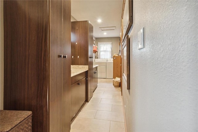 bathroom with vanity, tile patterned floors, and washer and clothes dryer