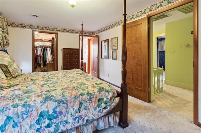 bedroom featuring carpet, a walk in closet, and a closet