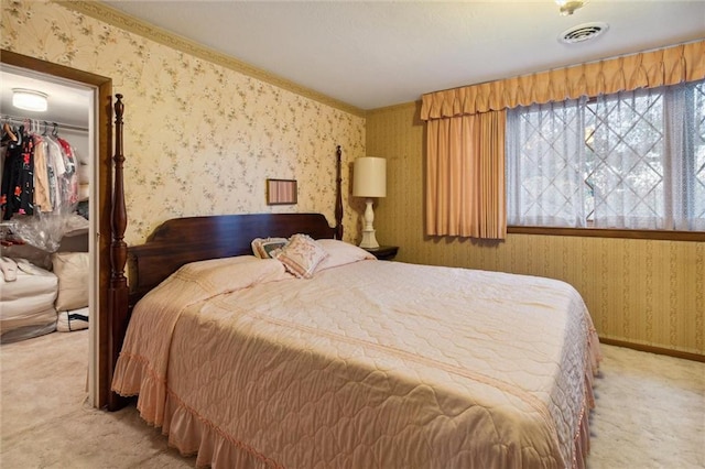 carpeted bedroom with a spacious closet and a closet