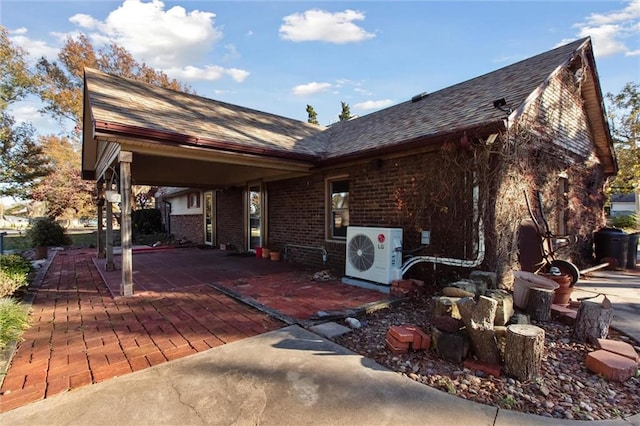 rear view of house with ac unit and a patio