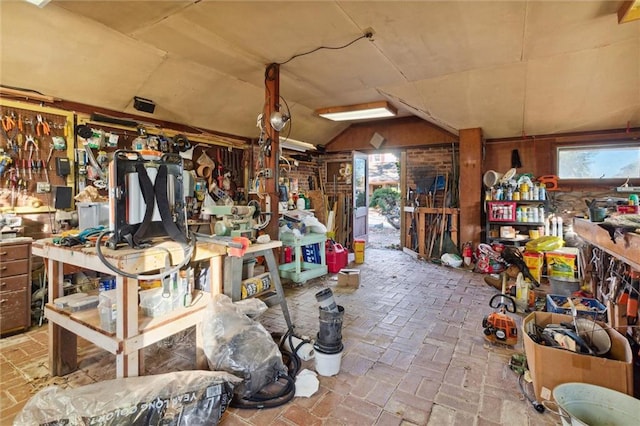 miscellaneous room with a workshop area and vaulted ceiling