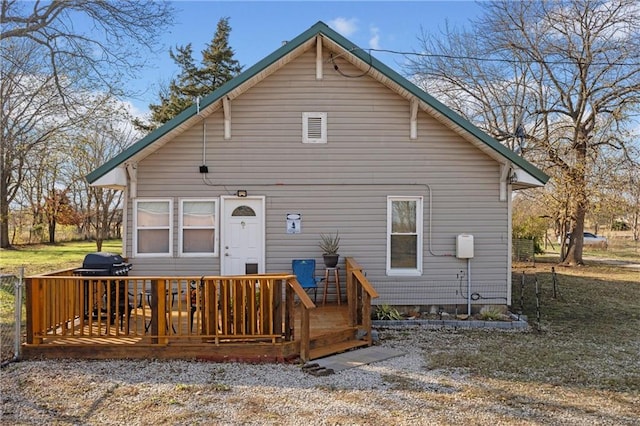 back of property with a wooden deck