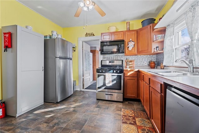 kitchen featuring backsplash, stainless steel appliances, ceiling fan, and sink