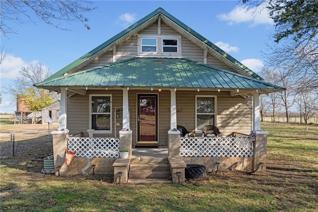 bungalow-style home with a front lawn and covered porch