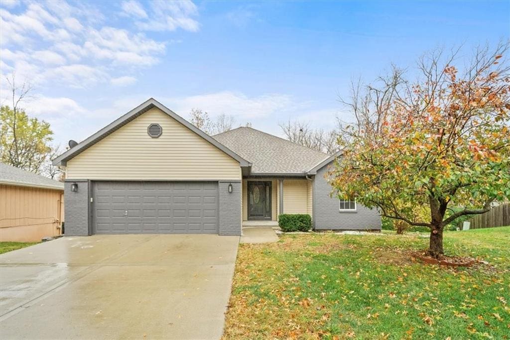 ranch-style house with a front yard and a garage