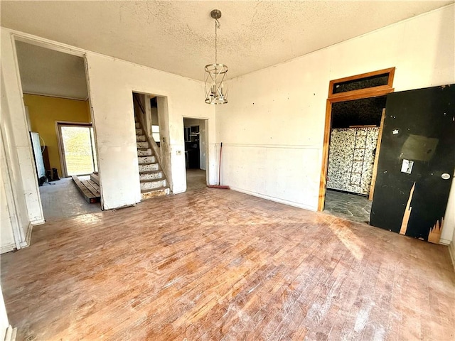 unfurnished room featuring hardwood / wood-style floors and a textured ceiling