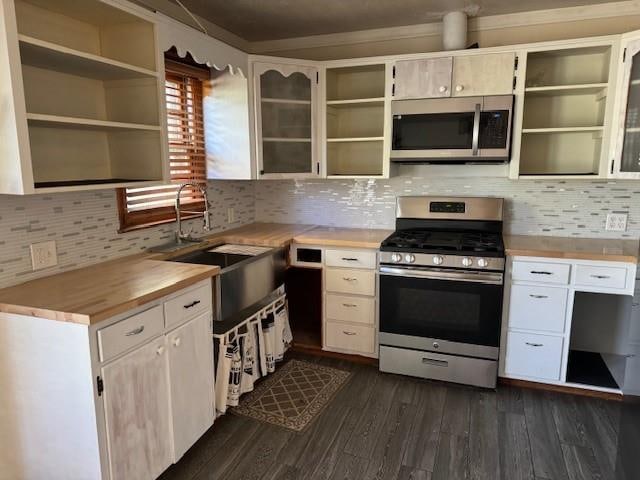 kitchen with decorative backsplash, dark hardwood / wood-style flooring, sink, and appliances with stainless steel finishes