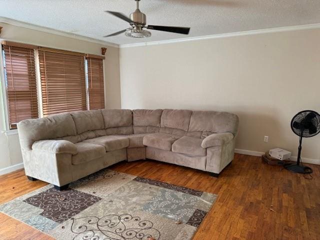 living room featuring ceiling fan, hardwood / wood-style floors, crown molding, and a textured ceiling