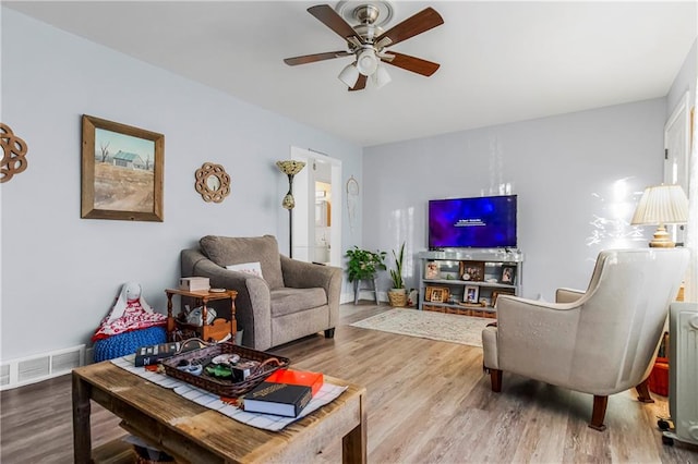 living room with ceiling fan and hardwood / wood-style flooring