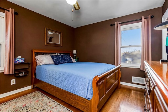 bedroom with hardwood / wood-style floors and ceiling fan