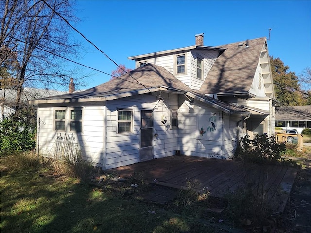 rear view of house featuring a deck