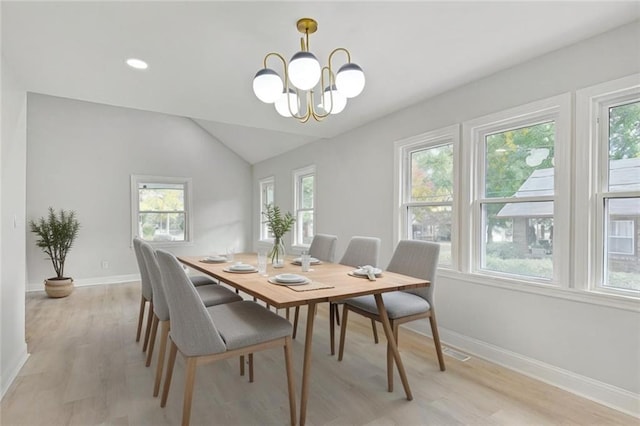 dining room with plenty of natural light, a chandelier, and light hardwood / wood-style flooring