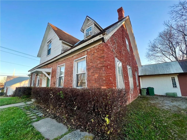 view of side of home featuring a yard