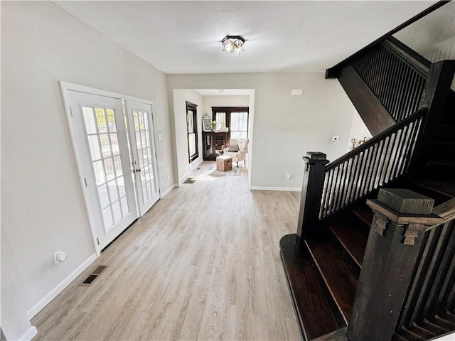1610 S Olive St, Pittsburg, KS 66762 - entrance foyer featuring stairway, light wood-style flooring, and french doors