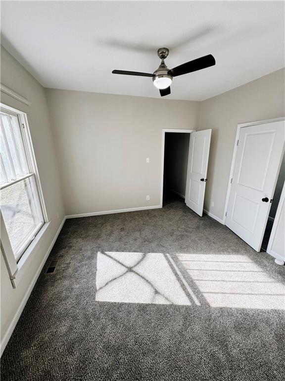 1610 S Olive St, Pittsburg, KS 66762 - unfurnished bedroom with carpet floors and ceiling fan