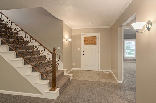 foyer entrance featuring carpet and crown molding