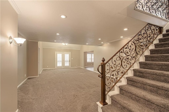 interior space with carpet flooring, ornamental molding, and french doors