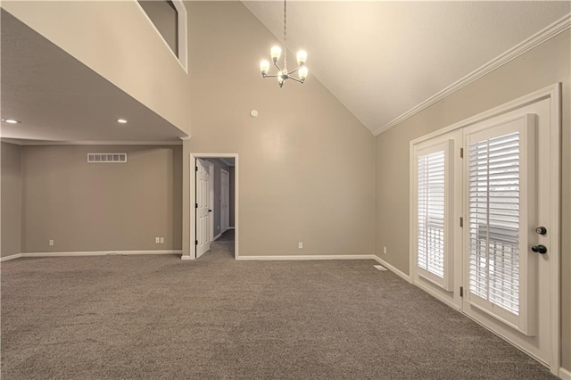 spare room with carpet, ornamental molding, high vaulted ceiling, and a notable chandelier