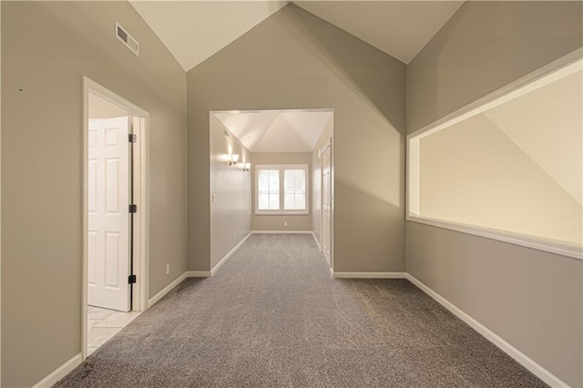 corridor featuring light carpet, lofted ceiling, and an inviting chandelier