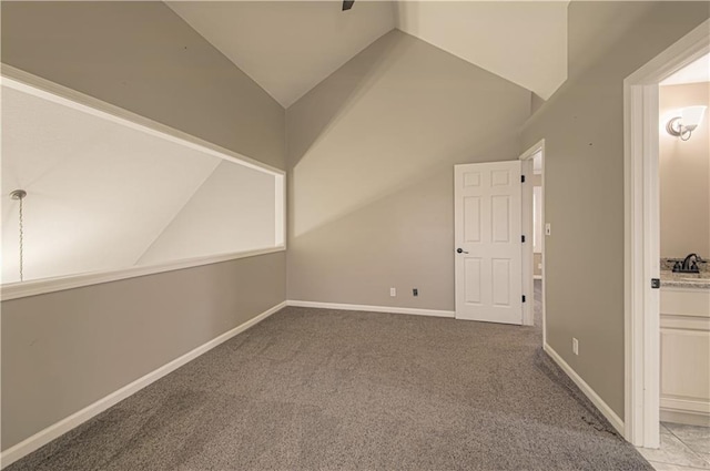 additional living space with light colored carpet and vaulted ceiling