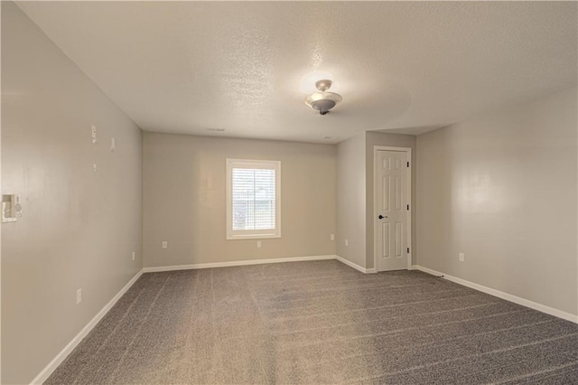 carpeted spare room featuring a textured ceiling